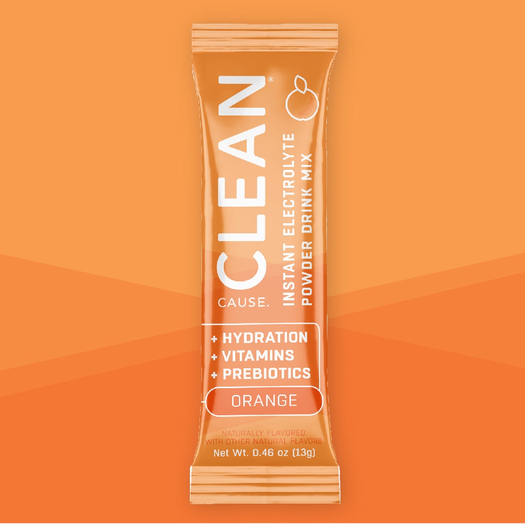 One CLEAN orange instant electrolyte drink mix packet on an orange background.